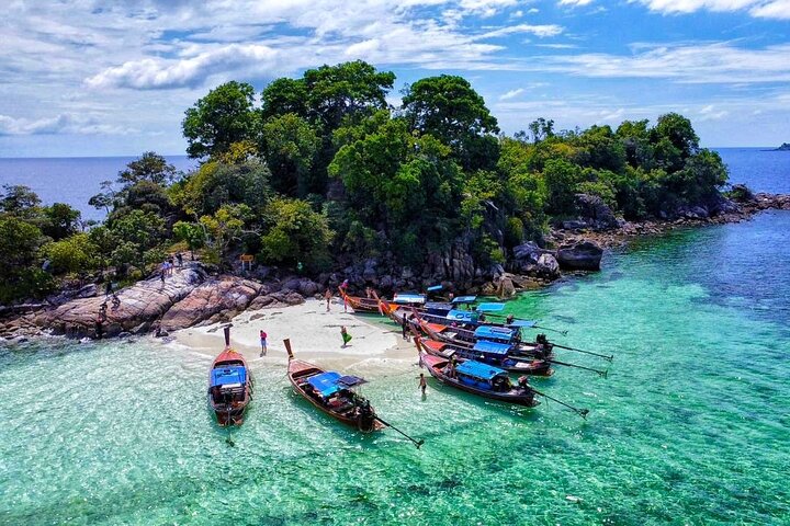 Snorkeling B Far way with longtail boat