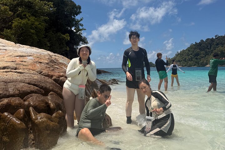 Snorkeling B Far way with longtail boat